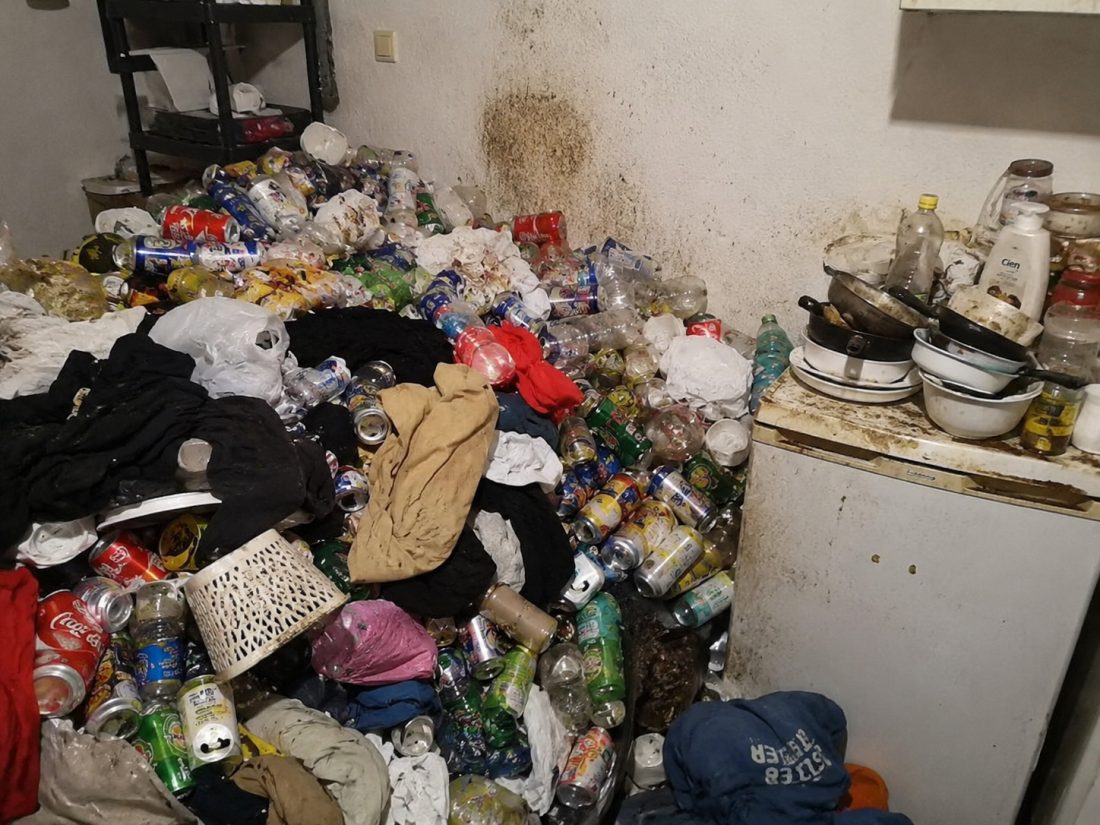 Logement insalubre encombré de canettes et détritus